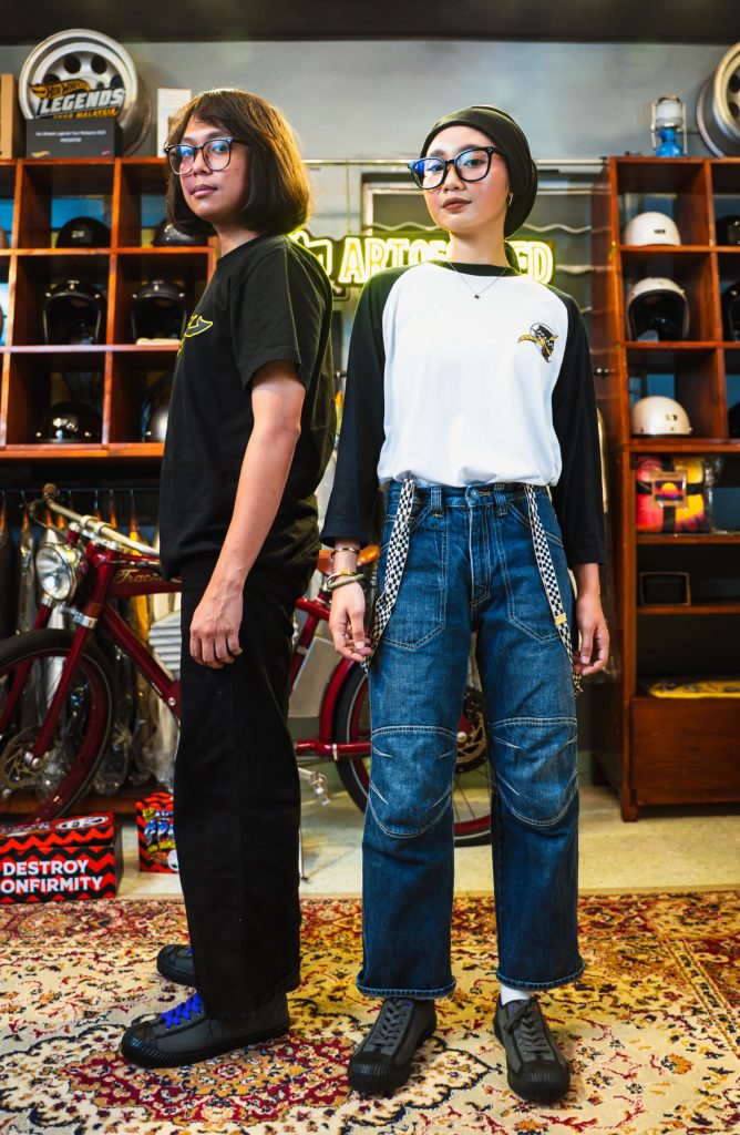 A male and a female models posing while wearing a pair of Fung Keong x Art Of Speed sneakers.