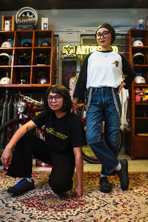 A male and a female models posing while wearing a pair of Fung Keong x Art Of Speed sneakers.